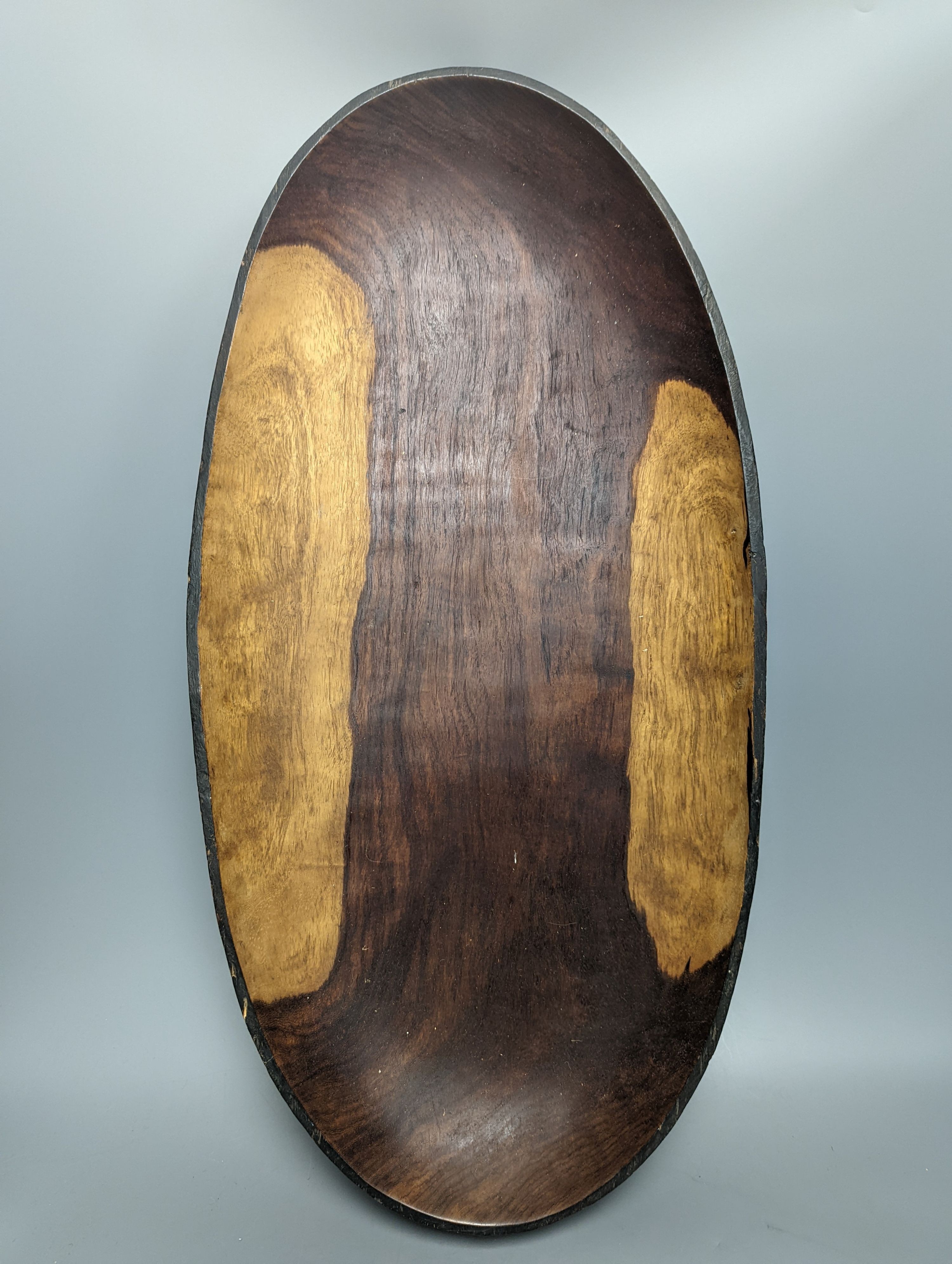 A large early 20th century West African hewn hardwood bowl raised on squared legs, length 63cm width 31cms